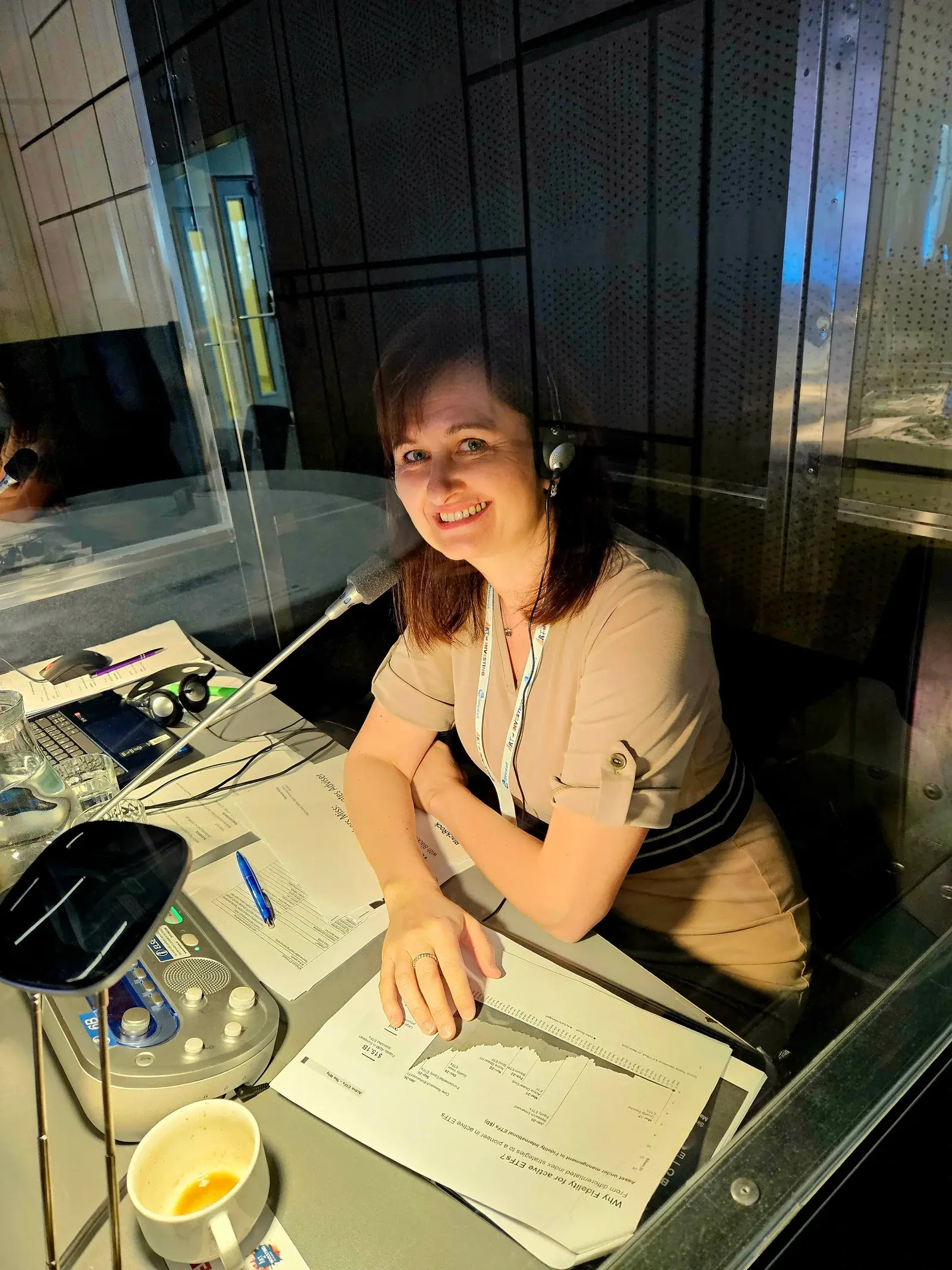 Mgr. Daniela Vránová interpreting from an interpreting booth at a conference